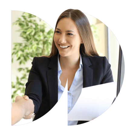 Female HR employee shaking a man's hand over the table and smiling in greeting