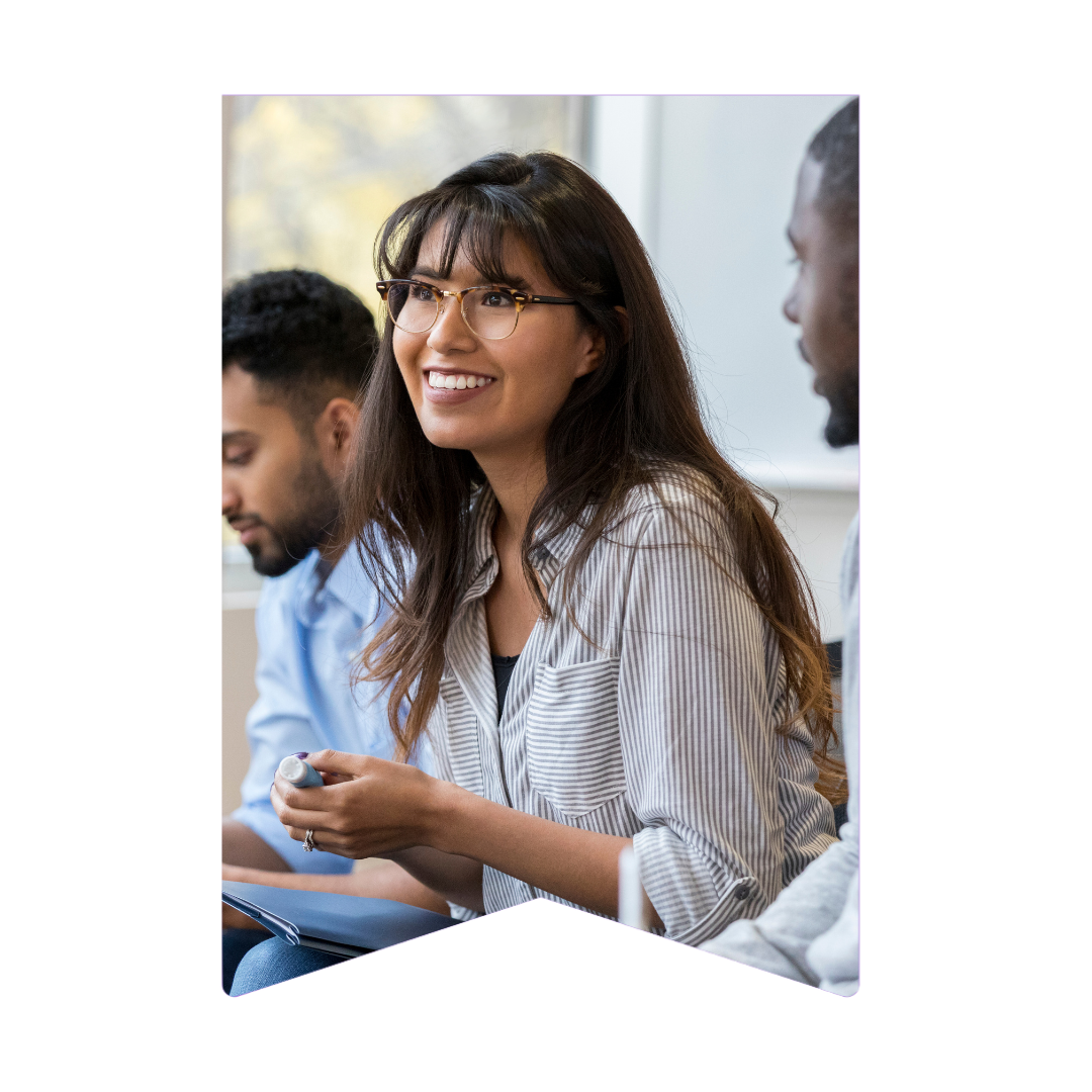 Smiling female employee sitting in a meeting